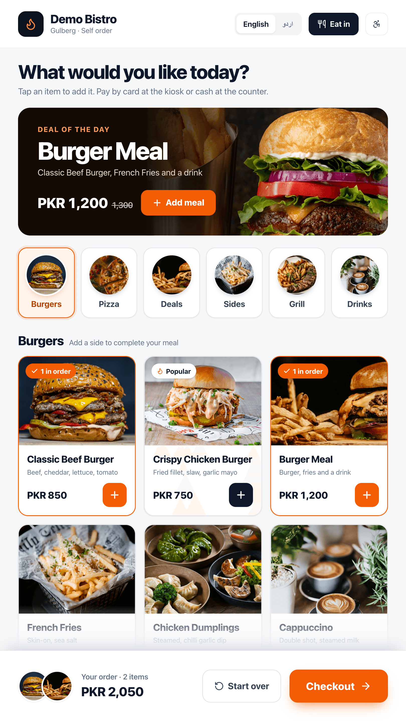 DineBills self-order kiosk screen with a deal of the day, category tiles with food photos, burger cards with prices and a Checkout button